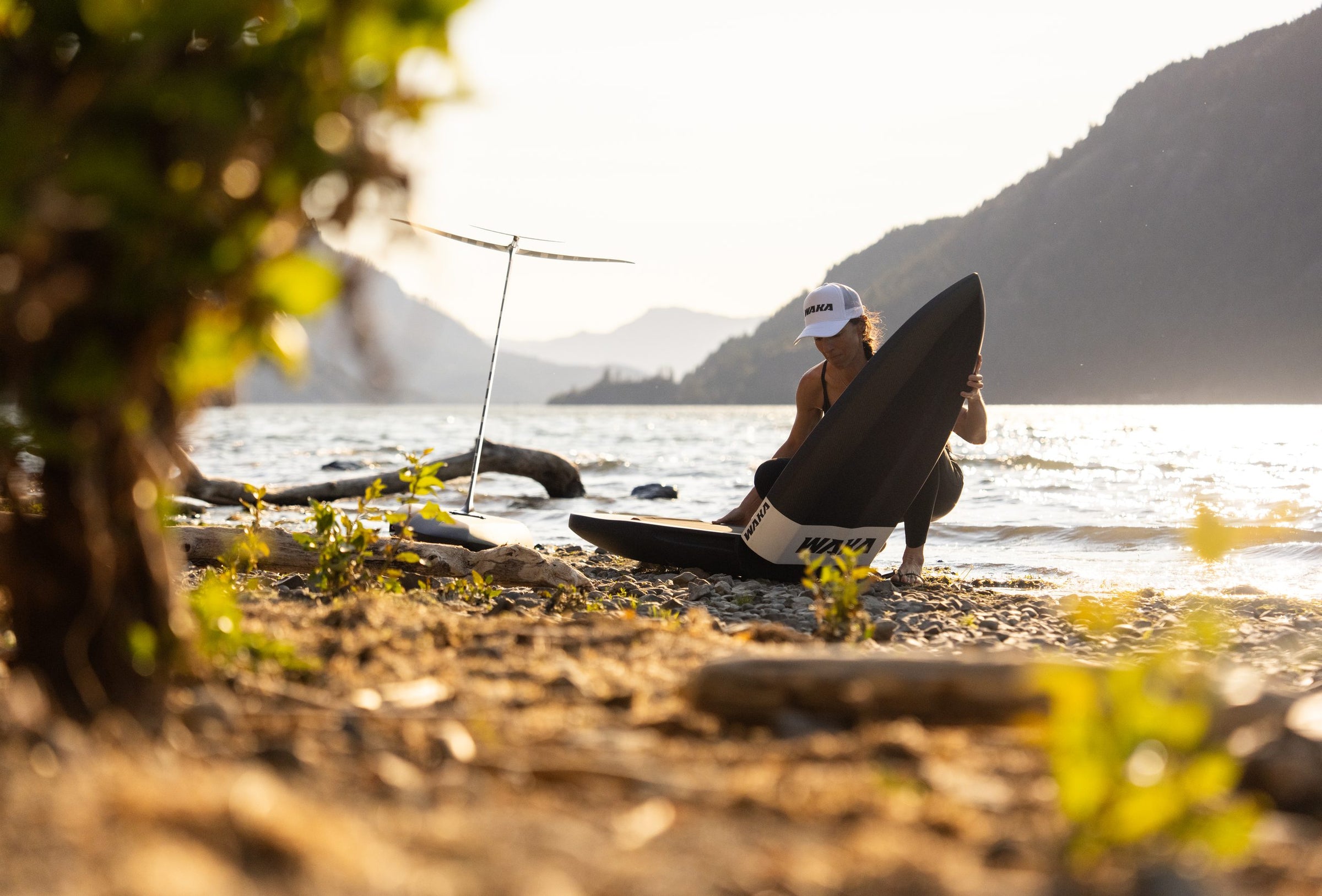 Rider folding a WAKA board at golden hour
