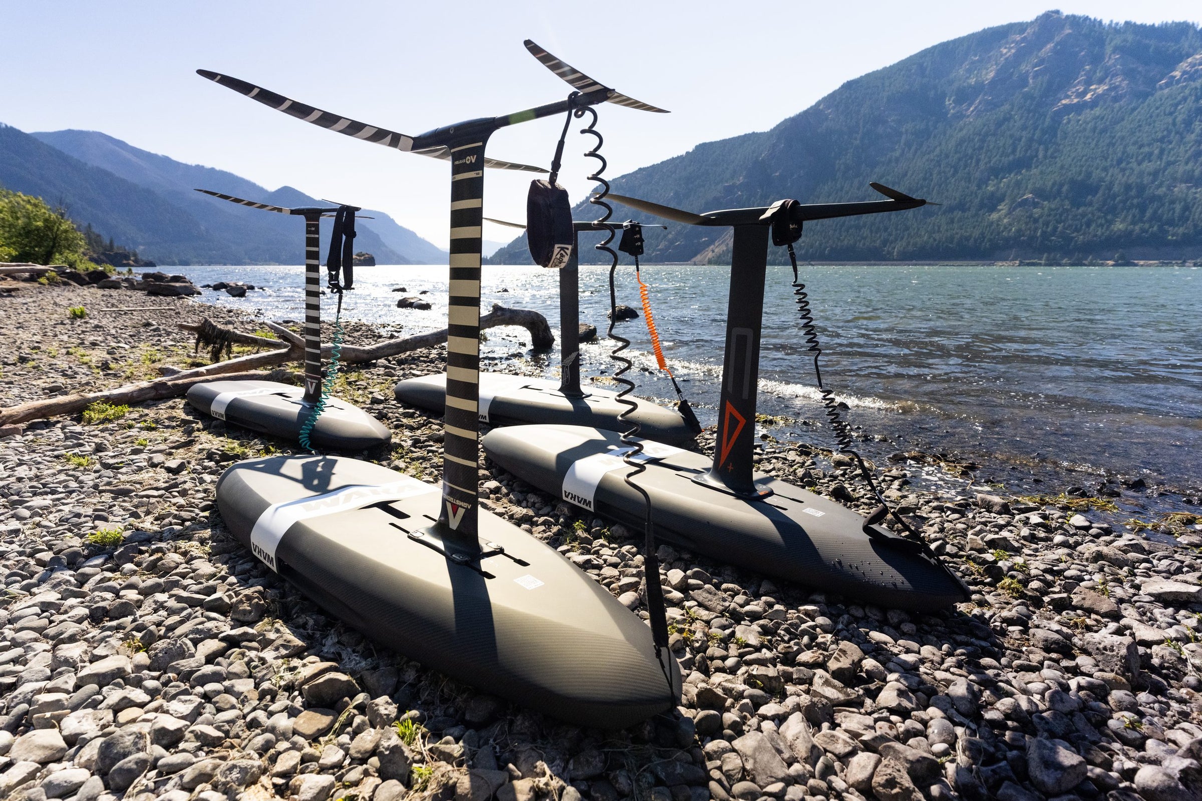 Three WAKA boards rigged on the shore